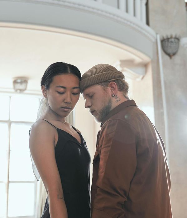 Woman in activewear performing a gentle cardio movement in a calm studio.